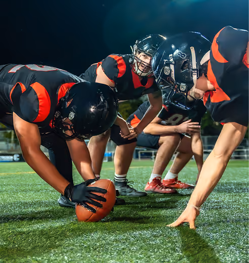 College football players lined up at the line of scrimmage